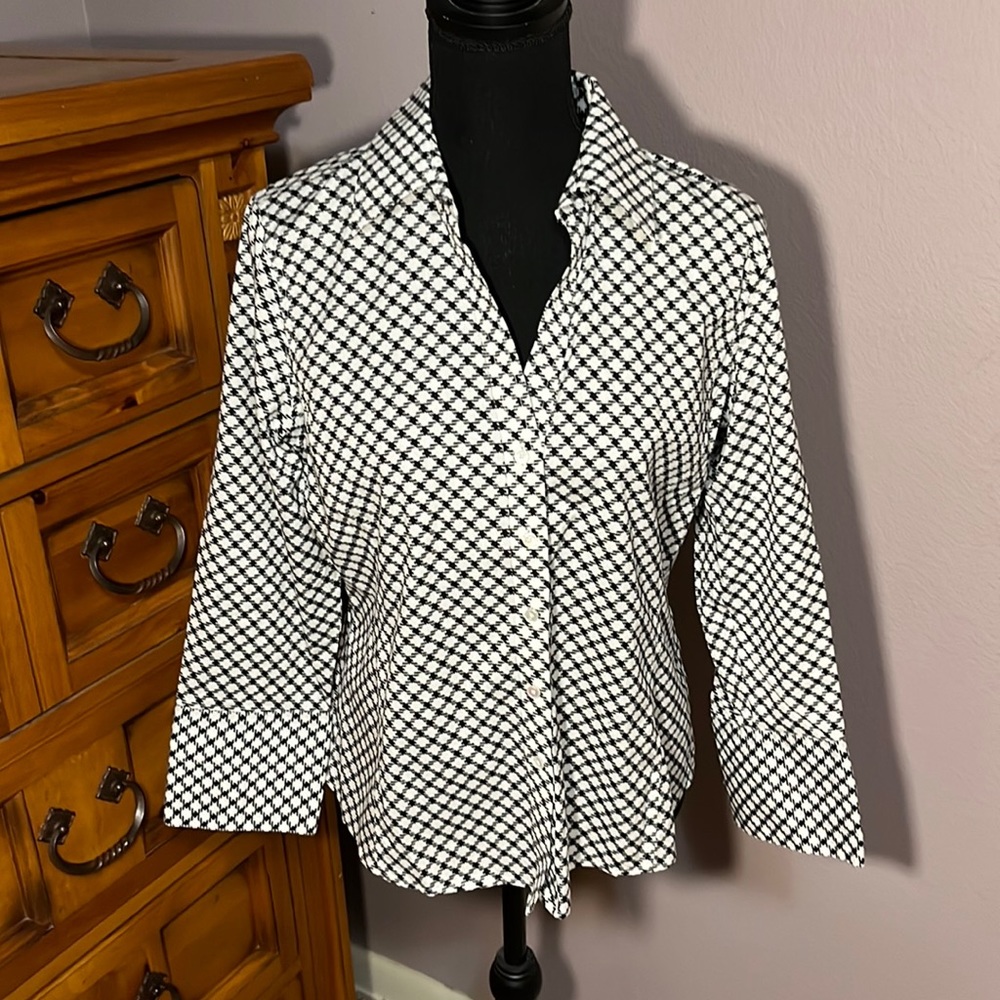 This is a classic button down shirt with a black and white checkered pattern